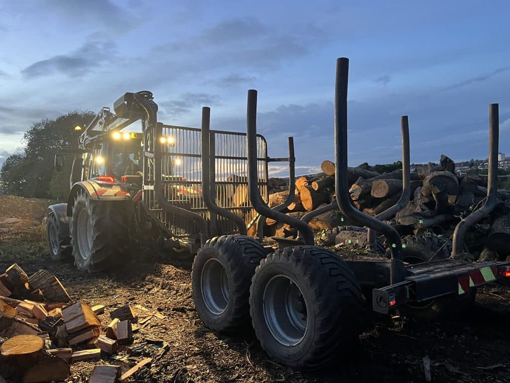 logs on trailer in dark