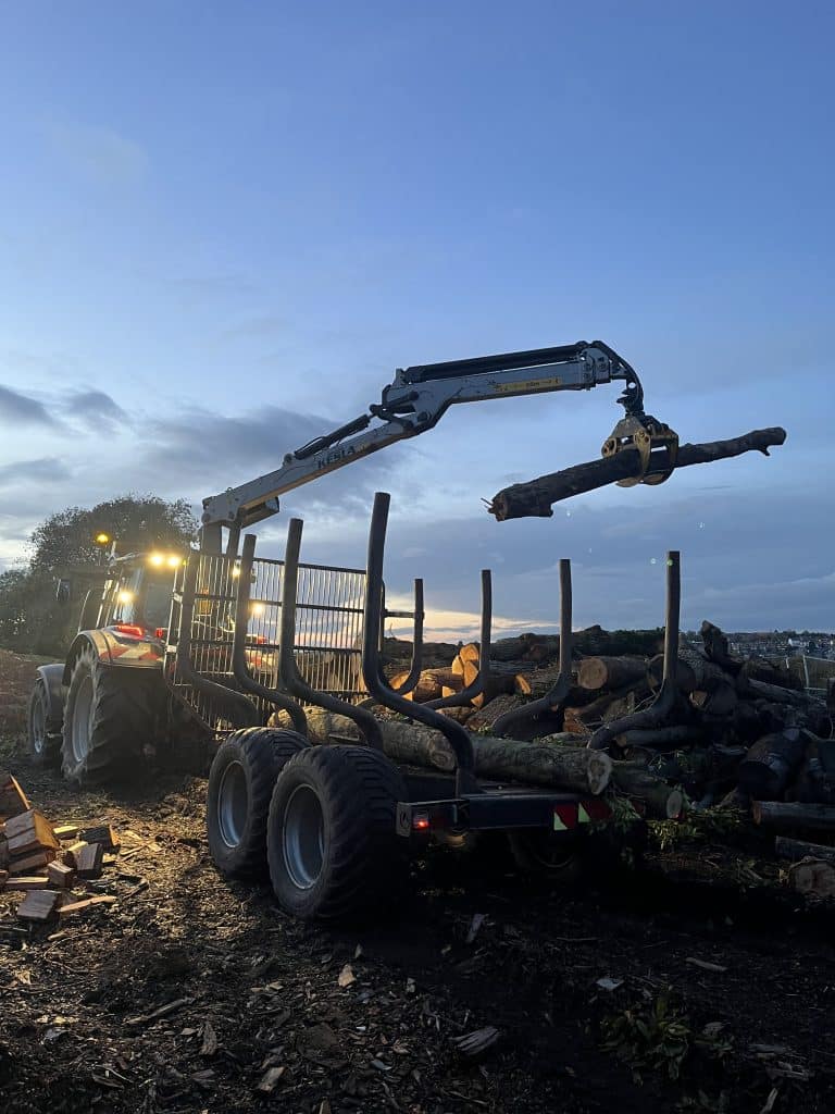 loading logs onto trailer on commercial site