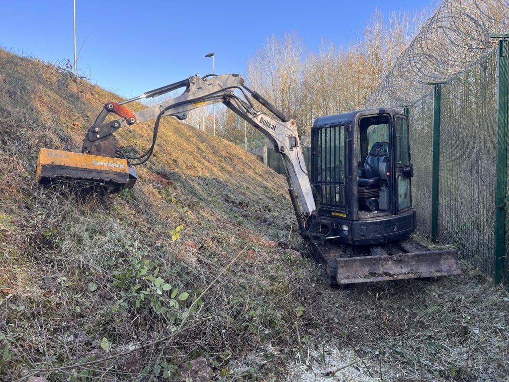 site clearance digger removing vegetation