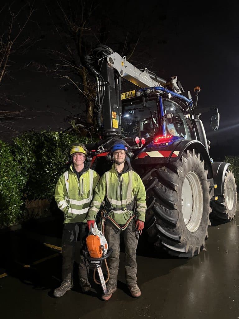 tree surgeons with equipment at night