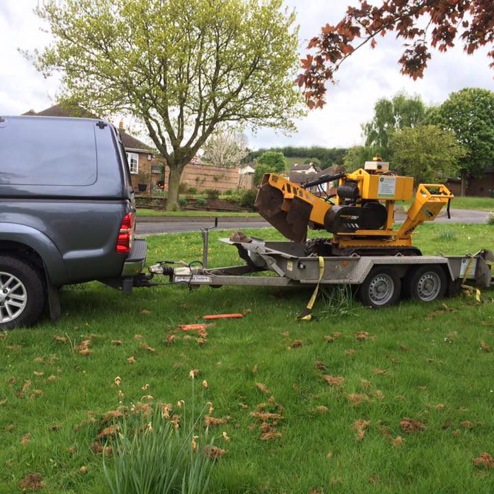 Arriving to Remove a Tree Stump. tree stump removal machine being towed
